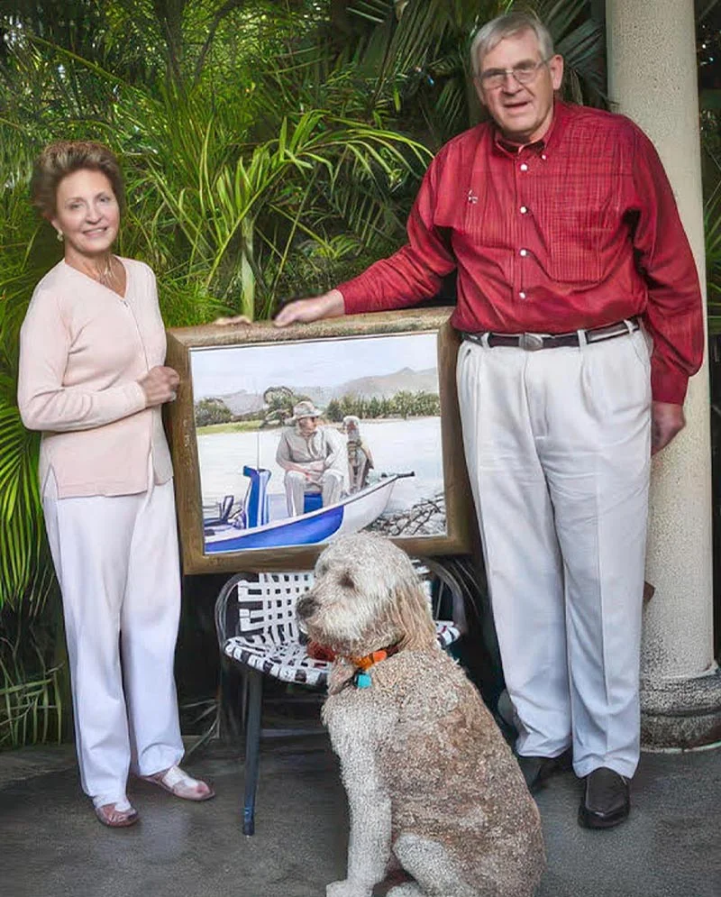 Happy Clients Holding Landscape Dog Portrait Happy clients proudly holding the finished oil painting of Henry and Daisy, showcasing the portrait in their home.