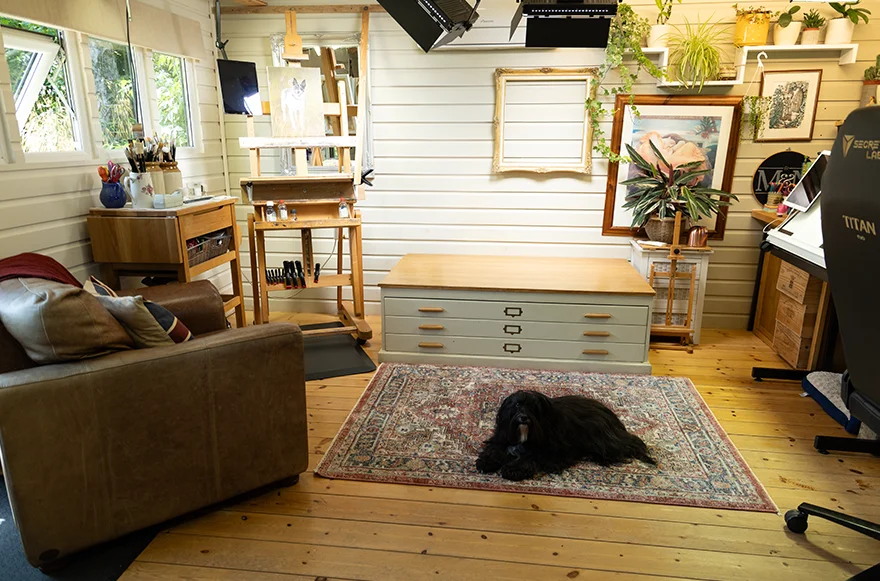 Client Seating Area and Vintage Plan Chest in the Art Studio A cozy client seating area within the art studio, featuring comfortable chairs and a vintage plan chest used for storage and packing.